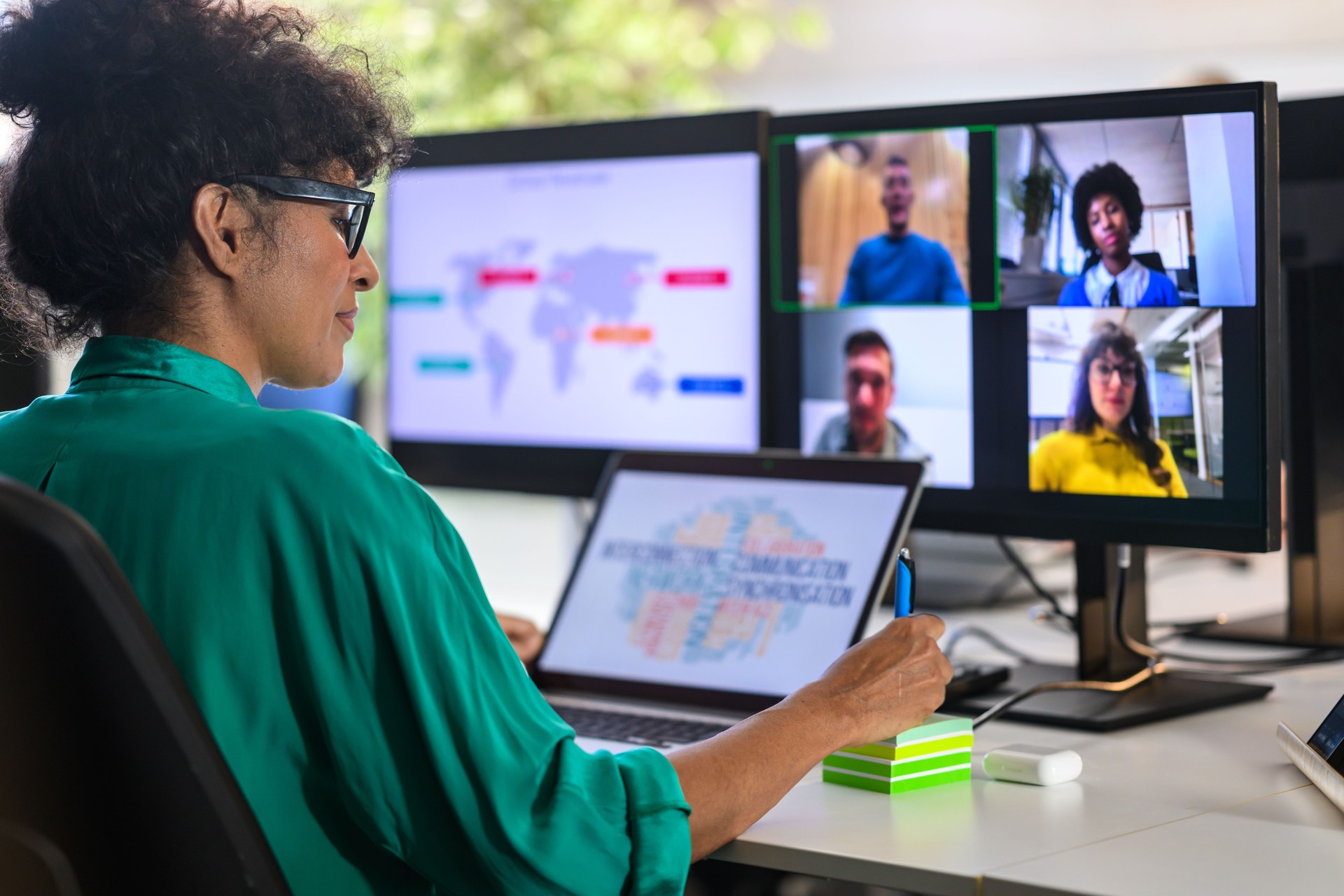 Woman discussing report with remote workers