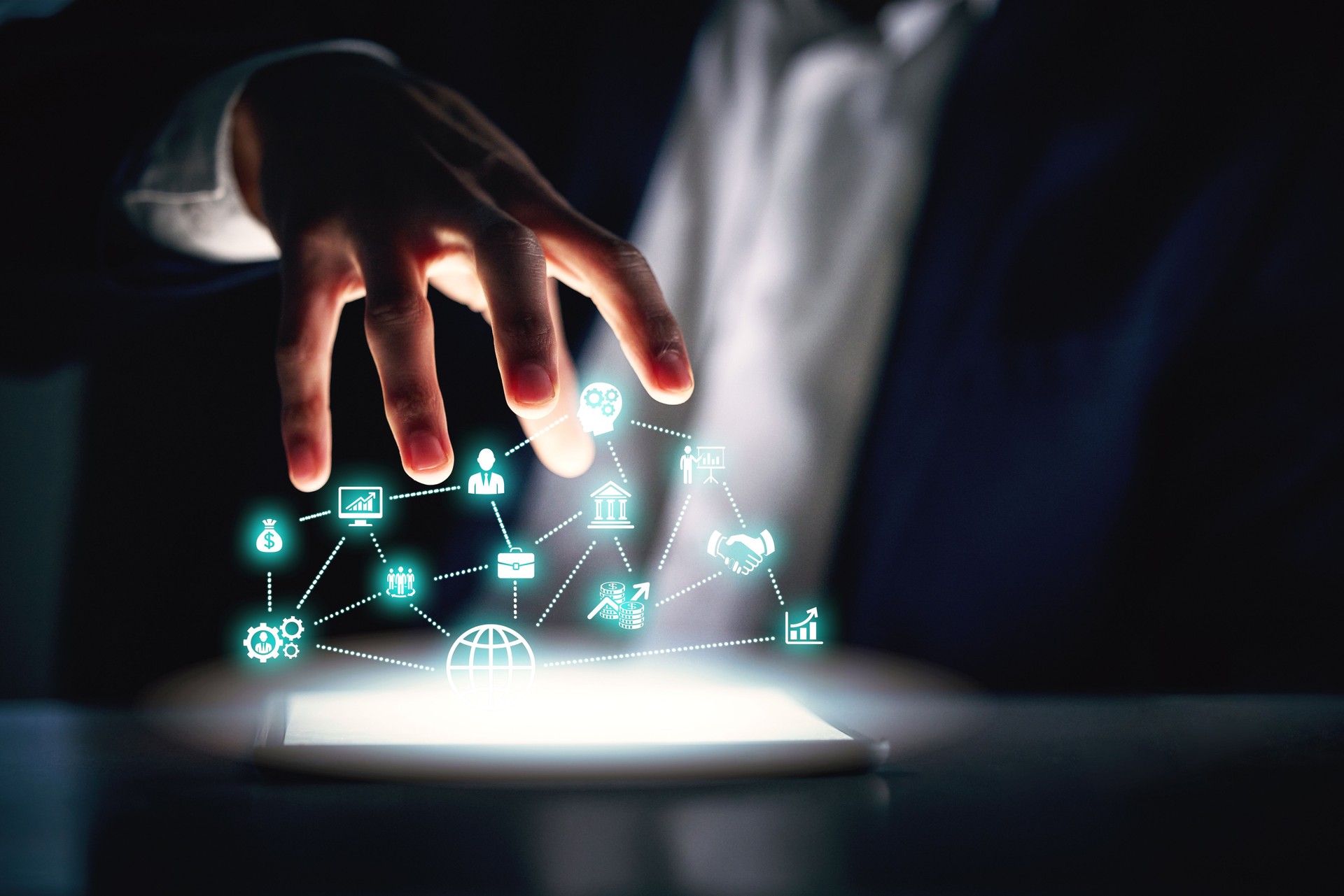 Cropped shot of an unrecognizable businessman working alone in the office at night and using a digital tablet